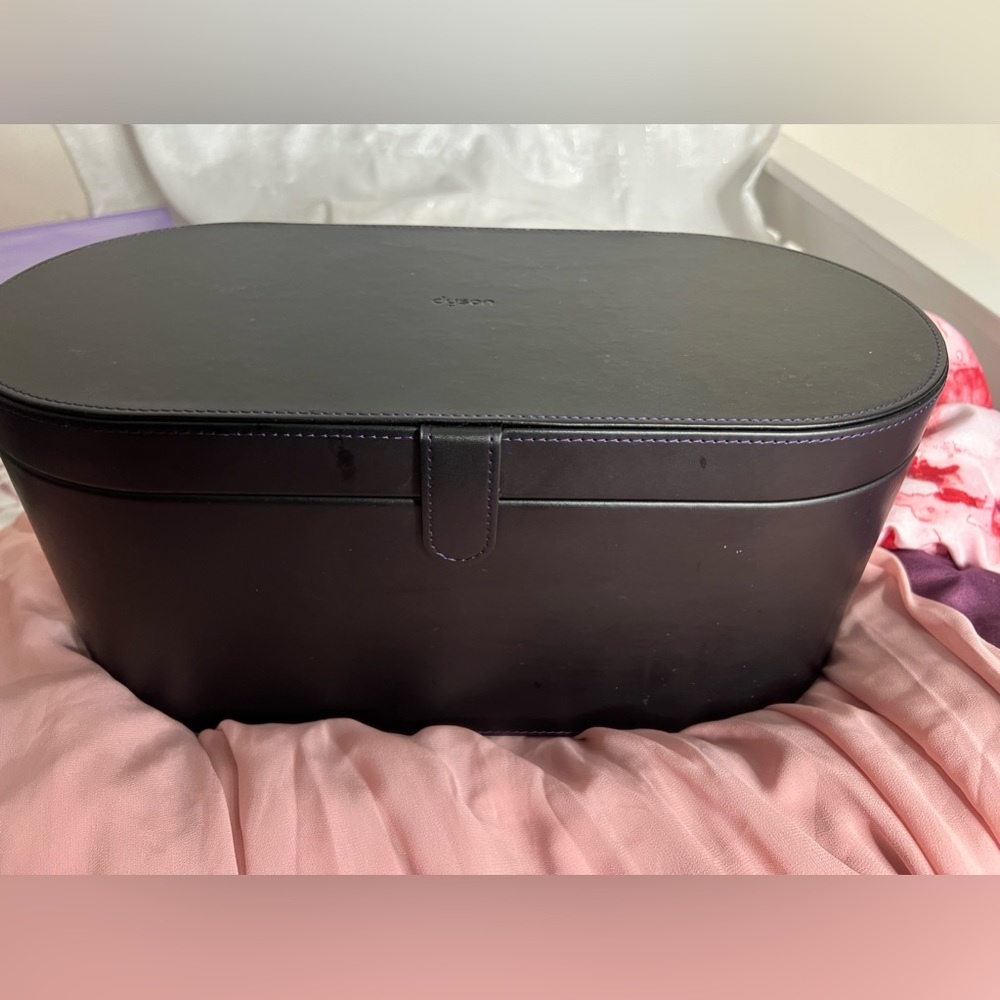 The Dyson blow dryer or accessories compartment